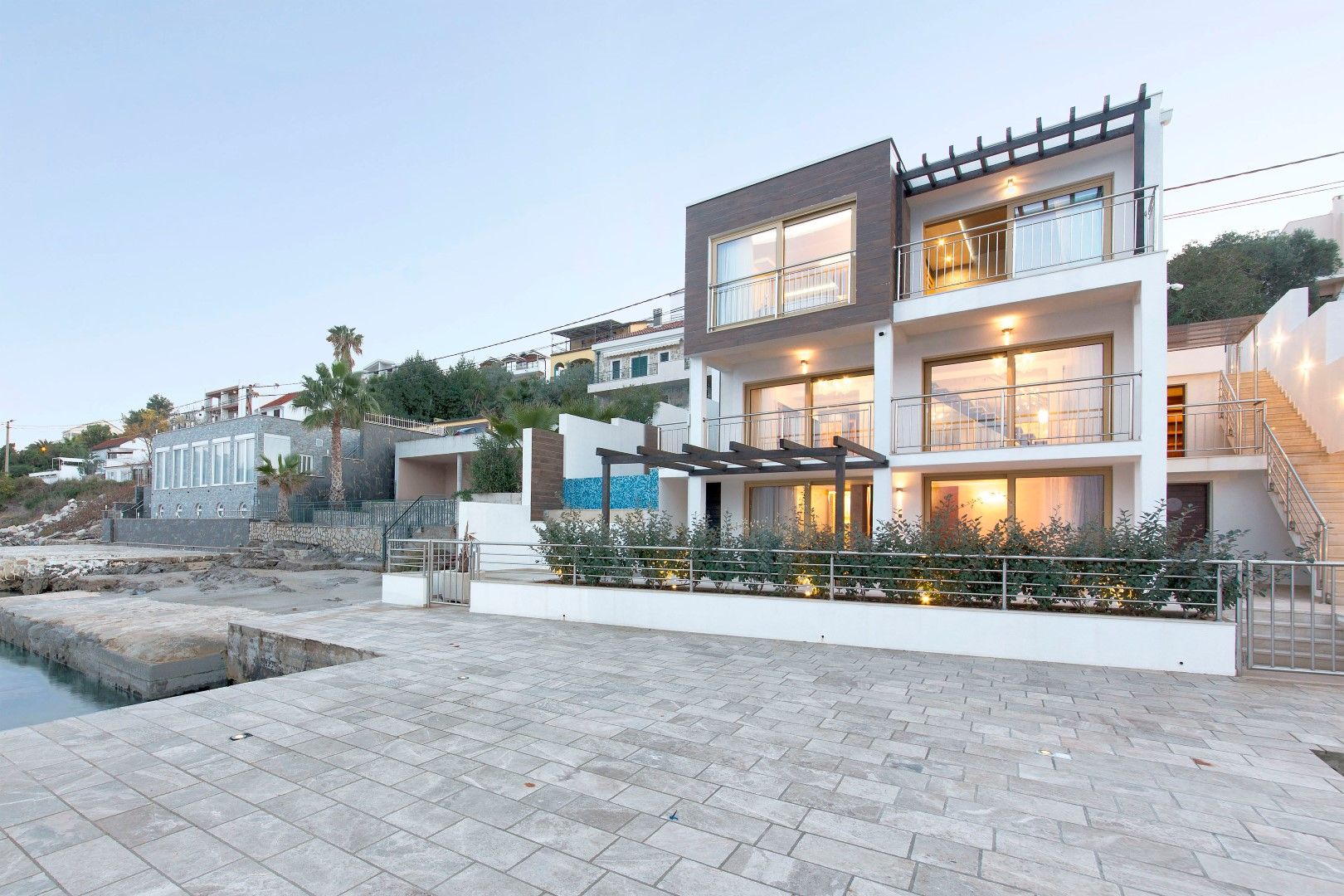 Modern three-story villa on the seafront in Krašići, Montenegro, with terraces and panoramic glazing.