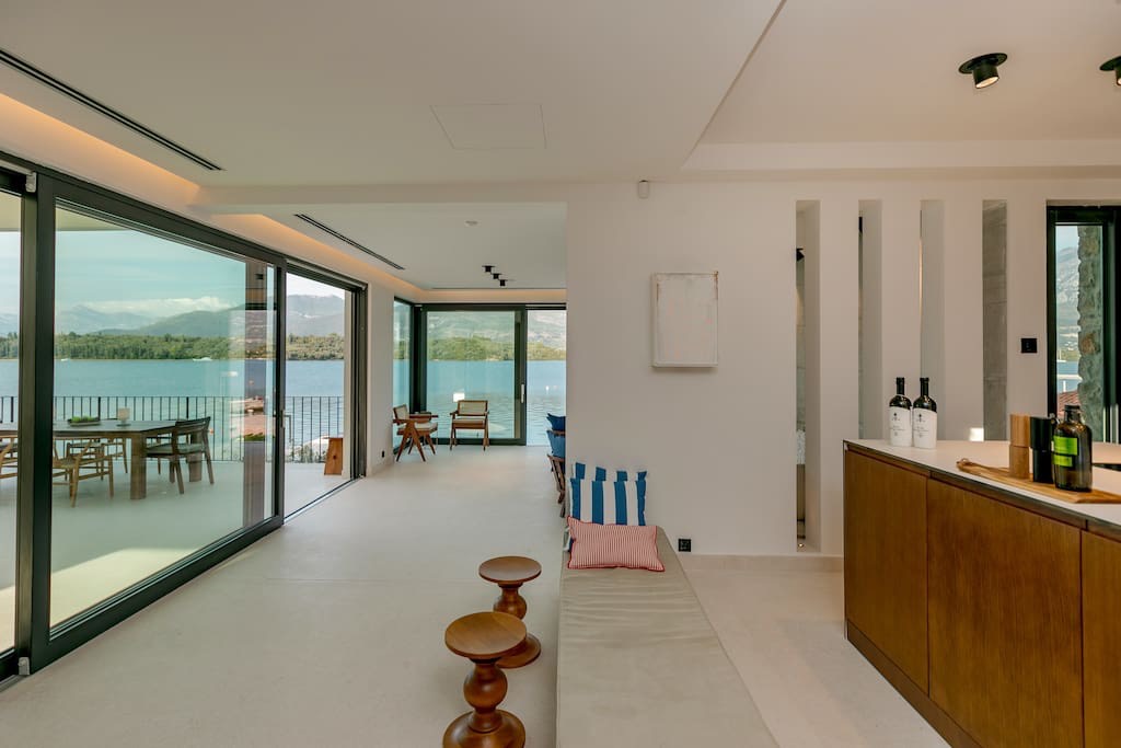 Villa living room on the first line in Luštica, Montenegro: panoramic windows with sea view, modern design, and a terrace.