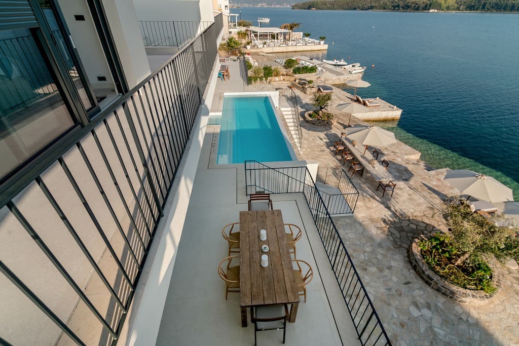 Villa terrace in Luštica, Montenegro: dining area, private pool, and direct sea view from the beachfront.