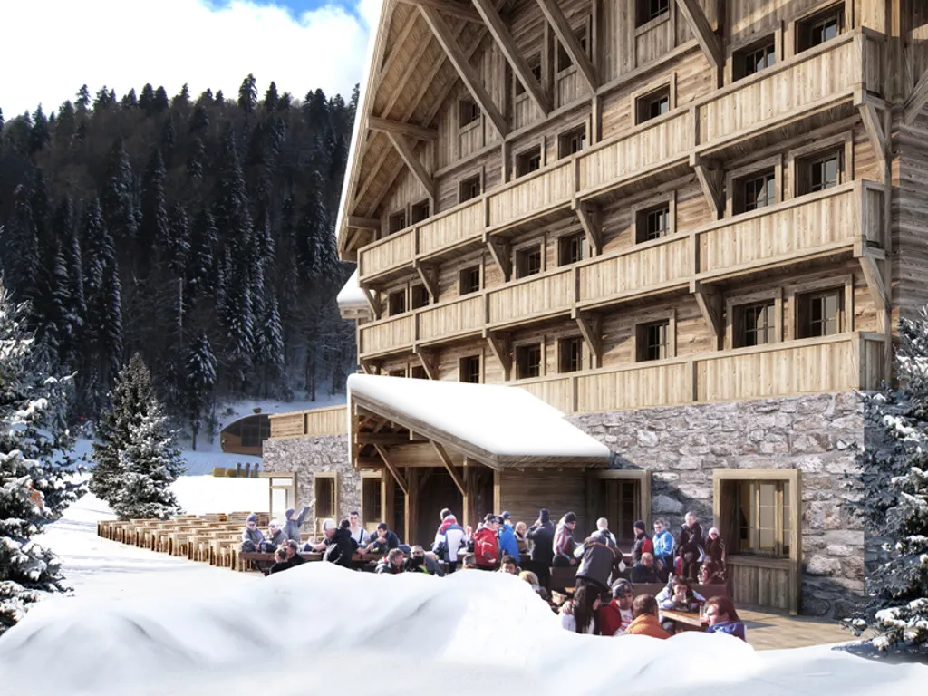 Exterior of a wooden alpine building with snow and people gathered outside.