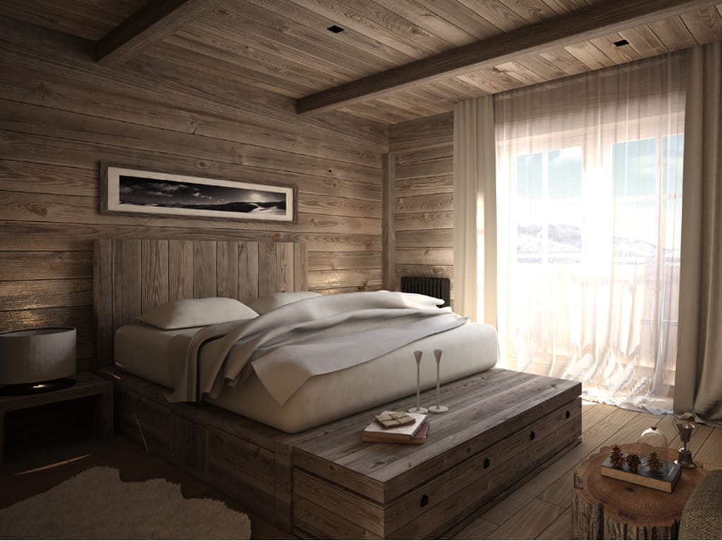 Bedroom in a hotel in Kolašin, Montenegro: wood finishes, a platform bed, and views of the Bjelasica mountains through a panoramic window