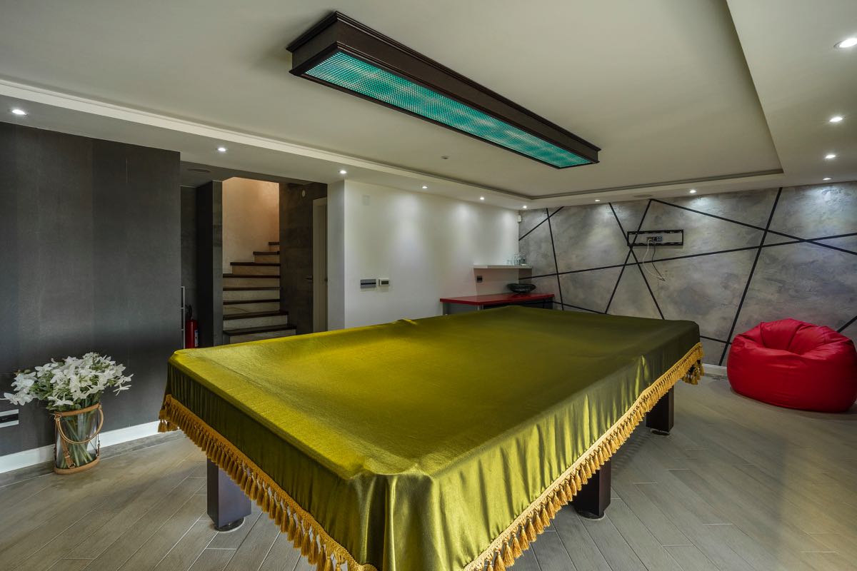 Game room with a billiard table and bean bag chair in a luxury villa in Budva, Montenegro. Modern interior design.