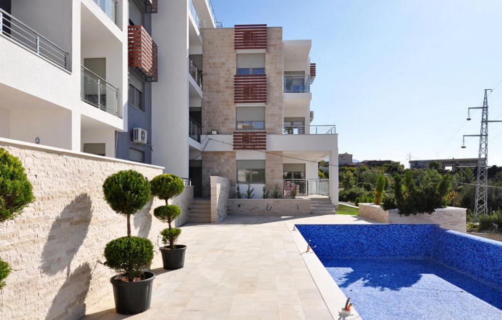 Modern residential complex with a pool and stone facade finish in Tivat, Montenegro.