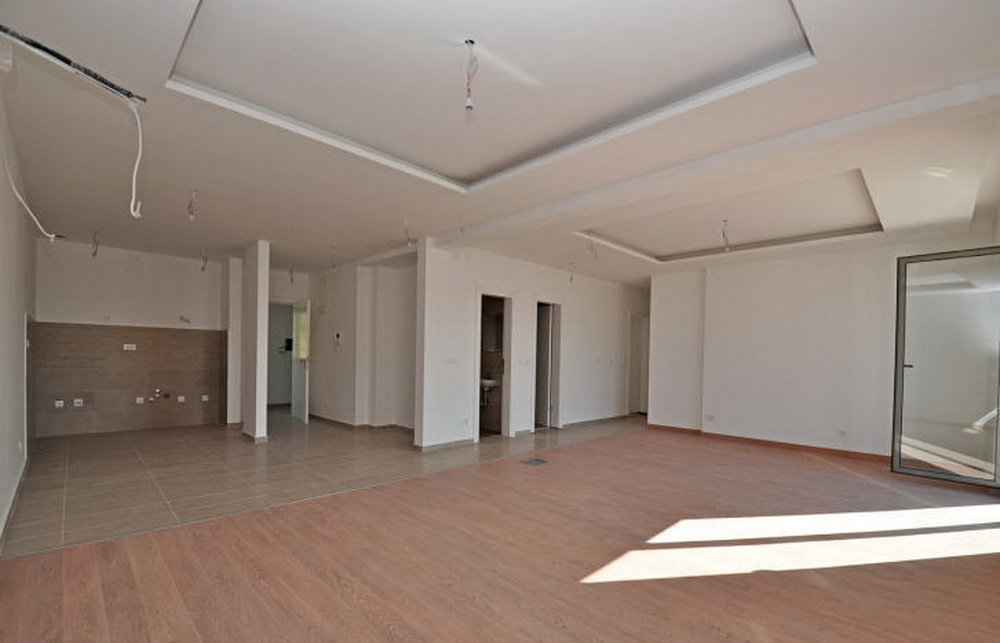 Spacious living room with finished interior in a new residential complex in Tivat, Montenegro, prepared for renovation.