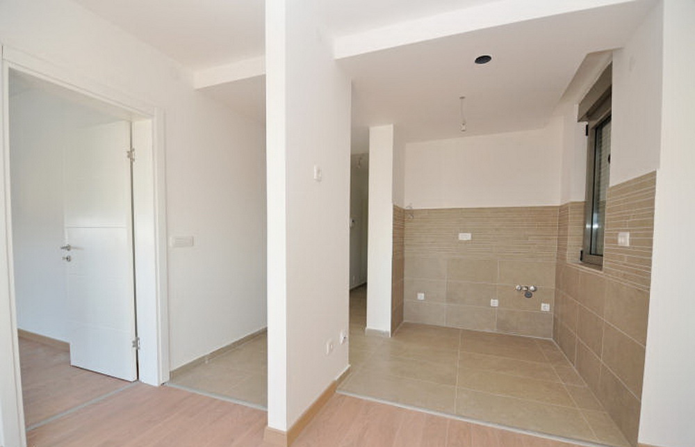 Kitchen interior with tiled finishes in a new building, Tivat, Montenegro. Bright room prepared for a kitchen set.