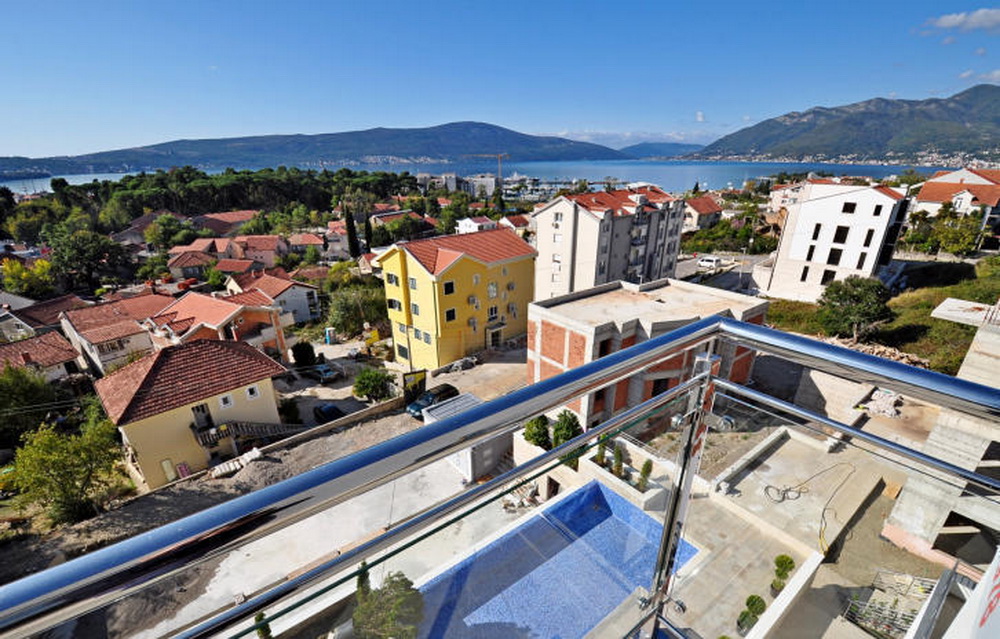 View from the balcony of the pool and the panorama of Tivat, Montenegro: a modern residential complex with a sea view.