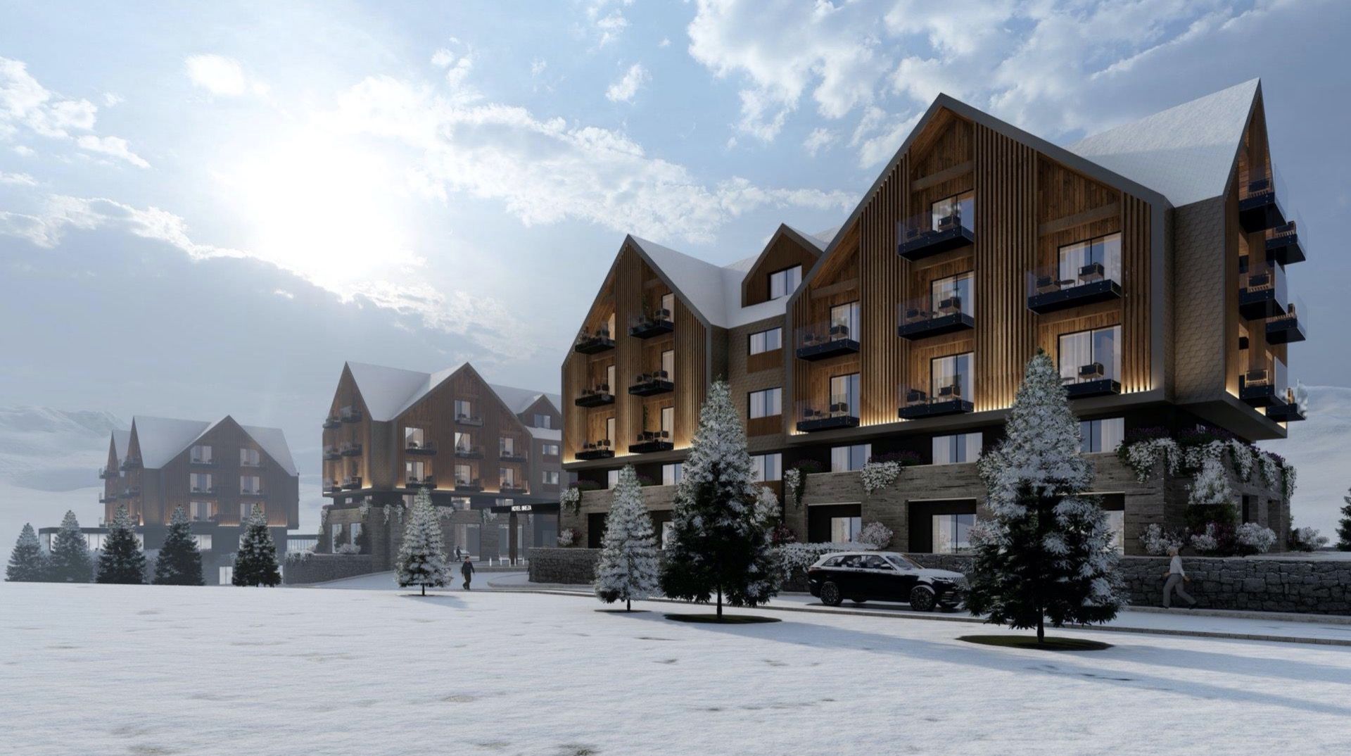 Modern chalet-style hotel in Kolašin, Montenegro: wooden facade, panoramic balconies, and snow-covered grounds.