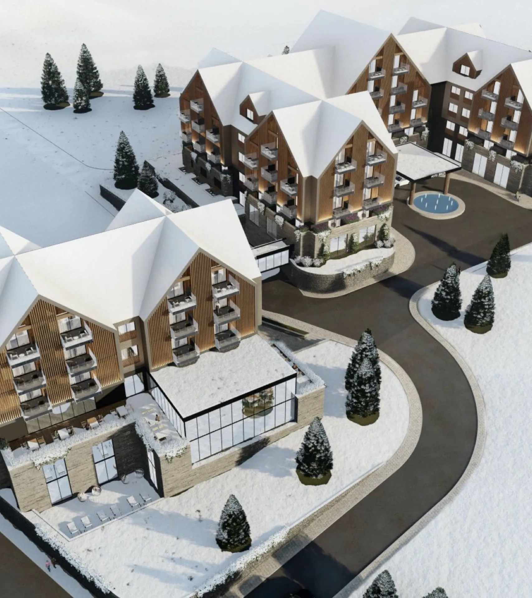 Aerial view of a snowy residential complex featuring wooden facades, balconies, and pine trees.