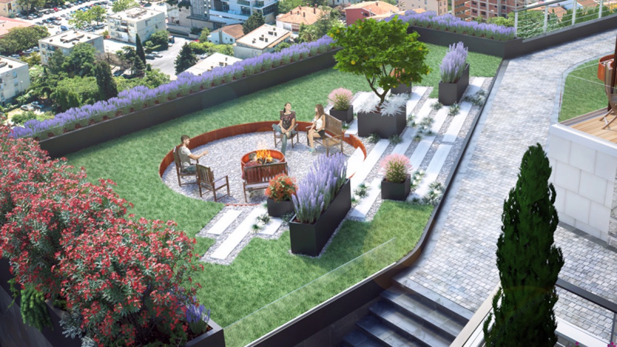 Landscaped rooftop terrace in a residential complex in Budva, Montenegro: lounge area with fire pit, landscaping, and city view.