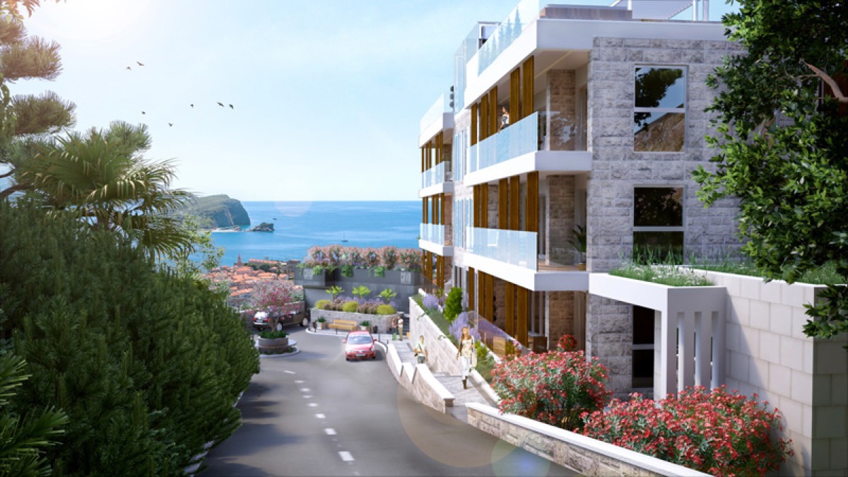 Modern residential complex in Budva, Montenegro: stone facade, panoramic terraces, and views of the sea and the old town.