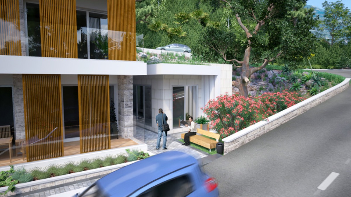 Modern residential complex in Budva, Montenegro: facade with wooden panels, terrace, and landscaping.