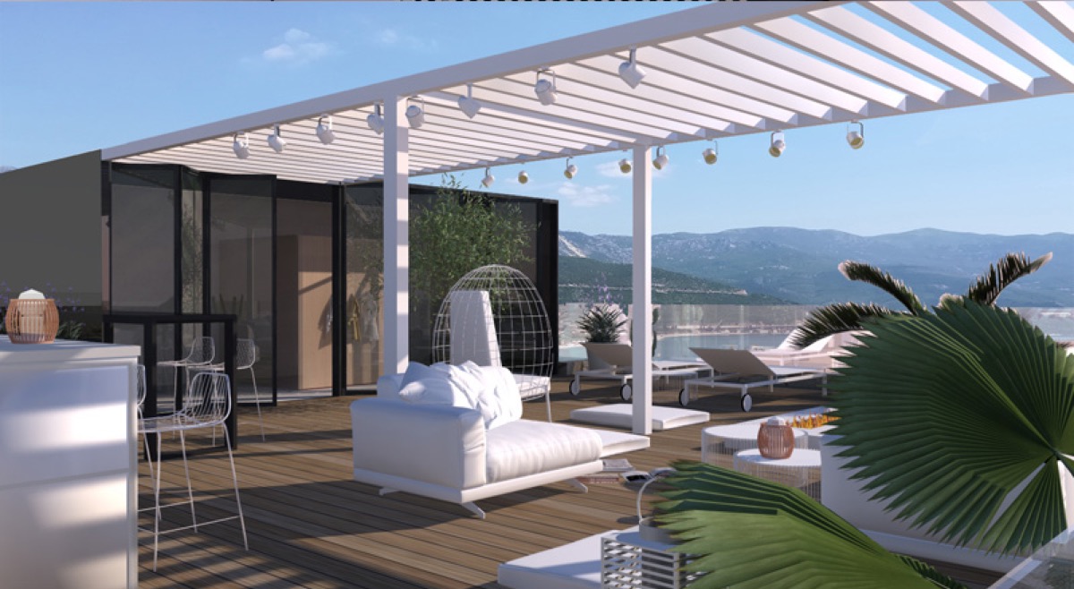Penthouse terrace in Budva, Montenegro: modern furniture, pergola, sea and mountain views, lounge area with sun loungers.