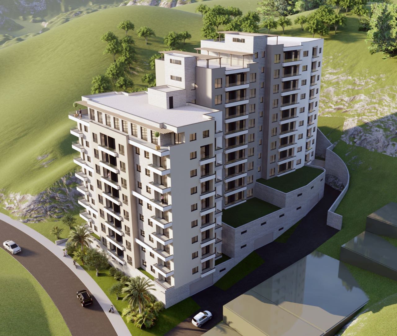 Aerial view of a modern residential complex in Bečići, Montenegro: a multi-story building with terraces and a mountain landscape.