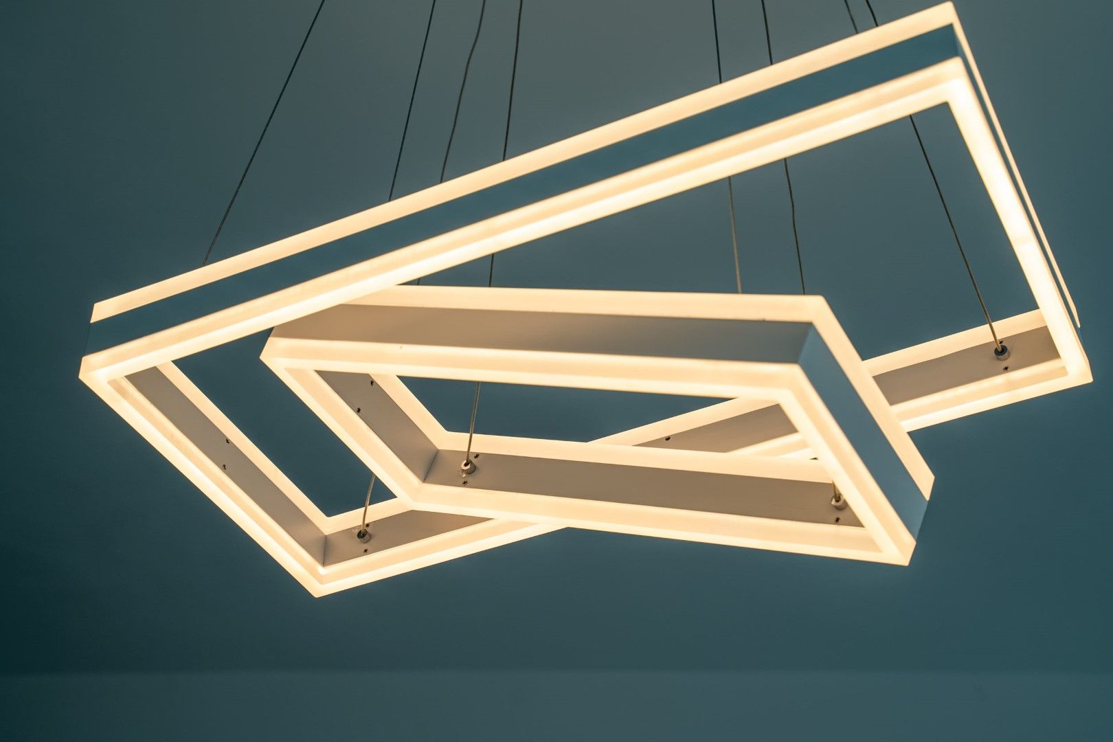 Modern LED chandelier in the interior of a house in Blizikuće, Montenegro. Stylish lighting in a luxury property.
