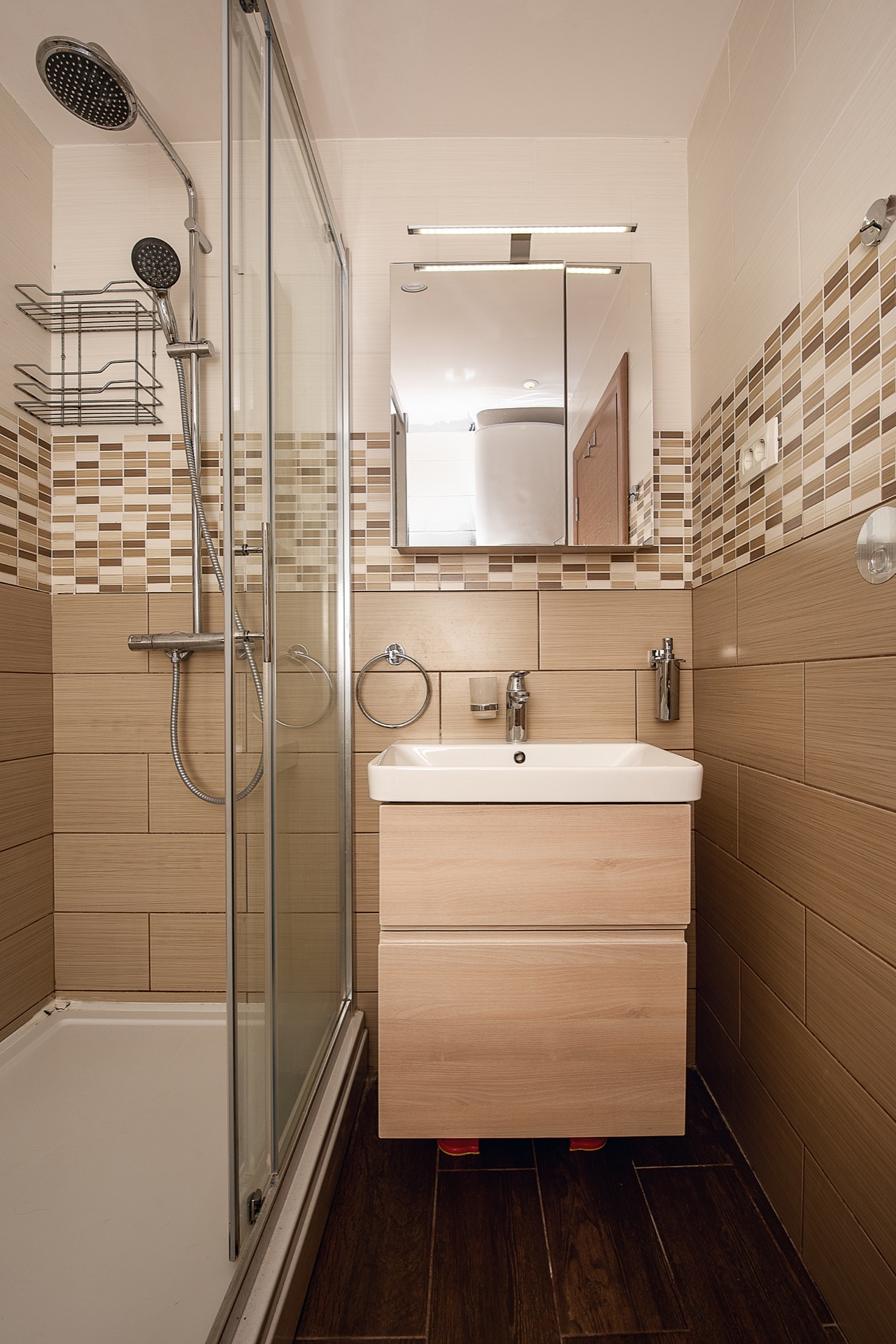 Modern bathroom with a shower cabin and vanity under the sink in an apartment, Budva, Montenegro.