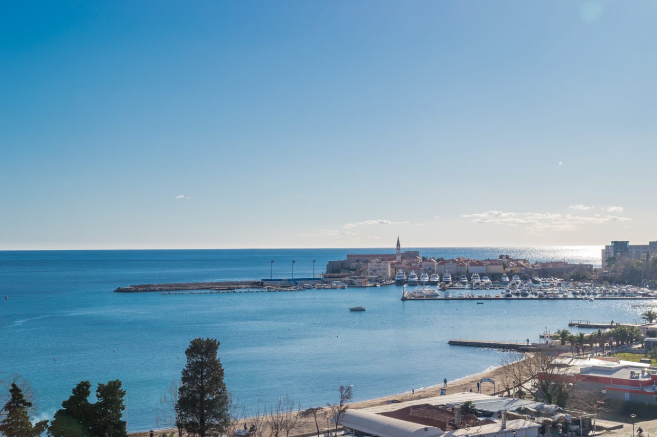 Panoramic view of the sea, beach, and Budva Old Town with the marina, Montenegro.