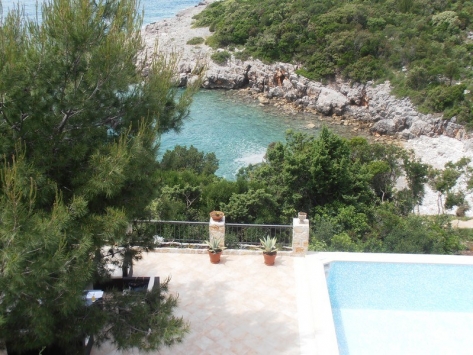 View of the pool and sea bay from the villa terrace in Luštica, Montenegro: coastal panorama and landscape design.