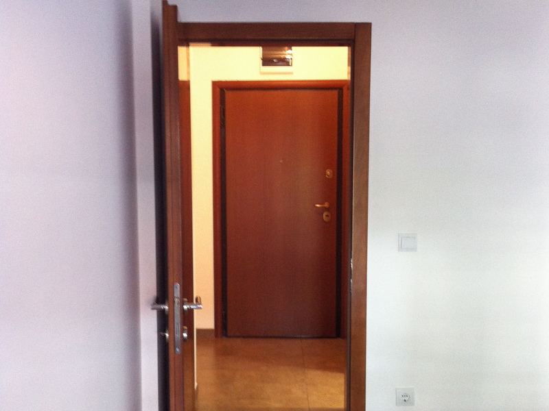 Interior door and entry area in the apartment, Petrovac, Montenegro: modern finishes and light-colored walls.