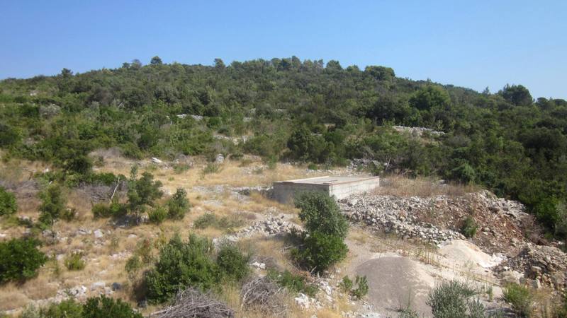 Land plot for construction in Zhanice, Montenegro: panoramic view of the hilly landscape with dense vegetation.