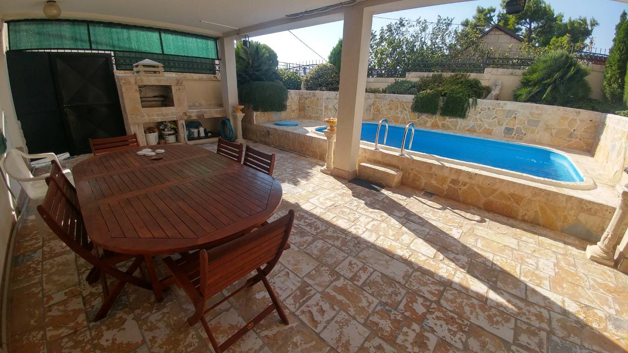 Terrace with a pool and barbecue area in the house, Ratac, Bar Riviera, Montenegro: wooden furniture and stone finishes.
