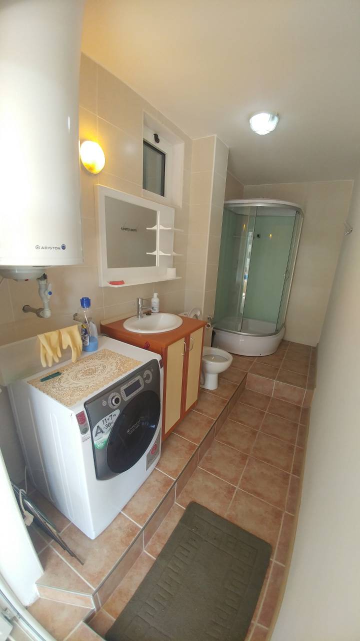 Bathroom in a house, Ratac, Bar Riviera, Montenegro: shower cabin, Ariston water heater, and washing machine.