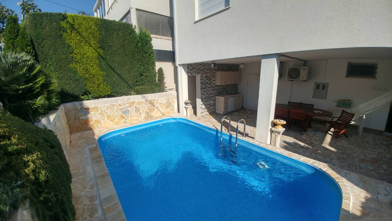 Private house with a pool and relaxation area on the Bar Riviera, Montenegro: a terrace with furniture and landscaping.