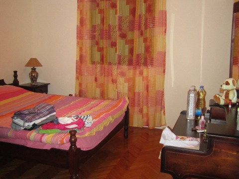 Cozy bedroom with a wooden bed and dressing table in a house for sale in Tivat, Montenegro.