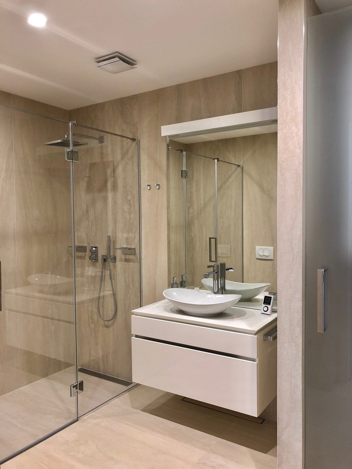 Modern bathroom with a shower cabin and a stylish sink in an apartment in Budva, Montenegro.
