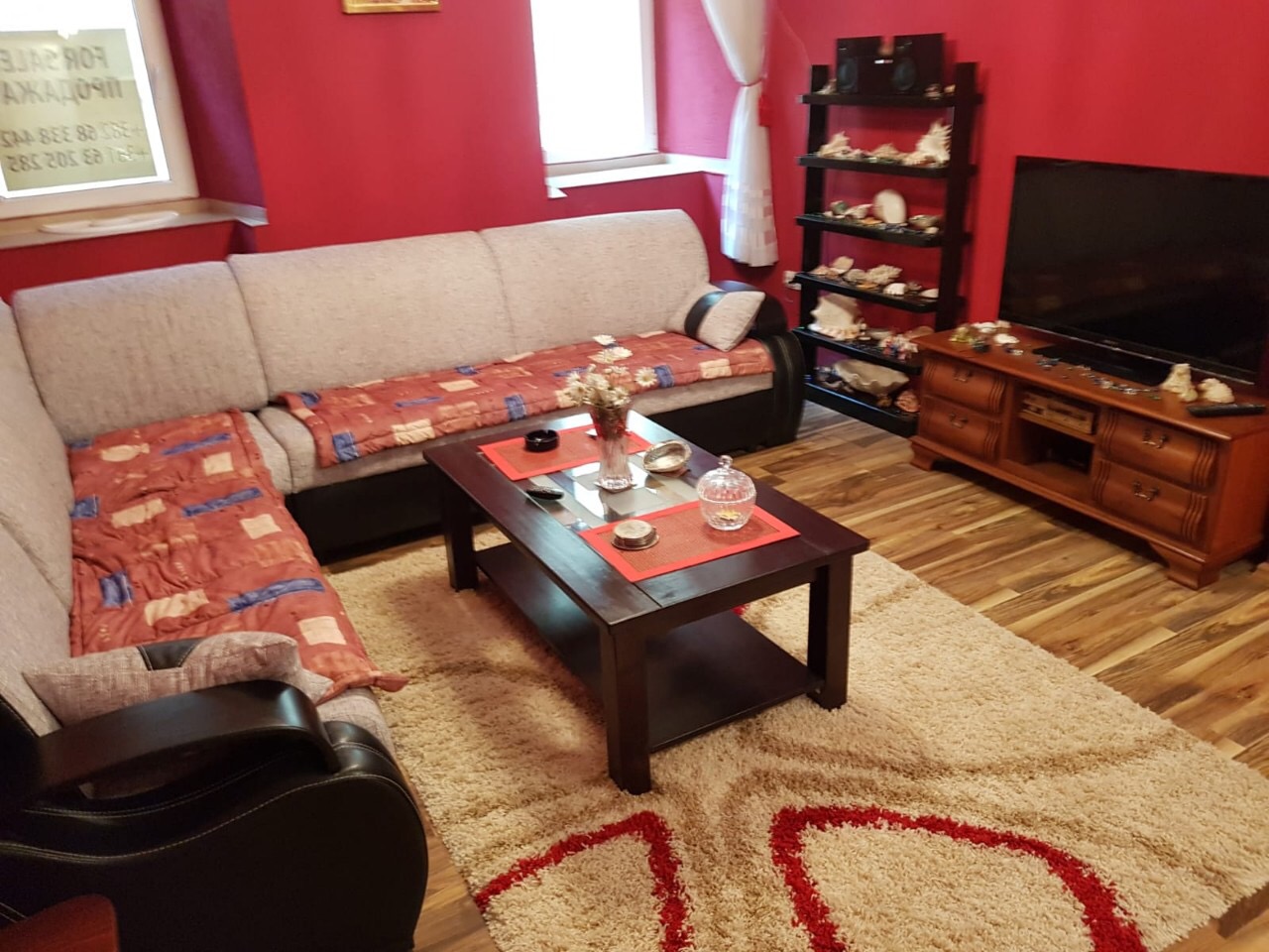 Cozy living room with a corner sofa, TV area, and bright interior in an apartment for sale, Budva, Montenegro.