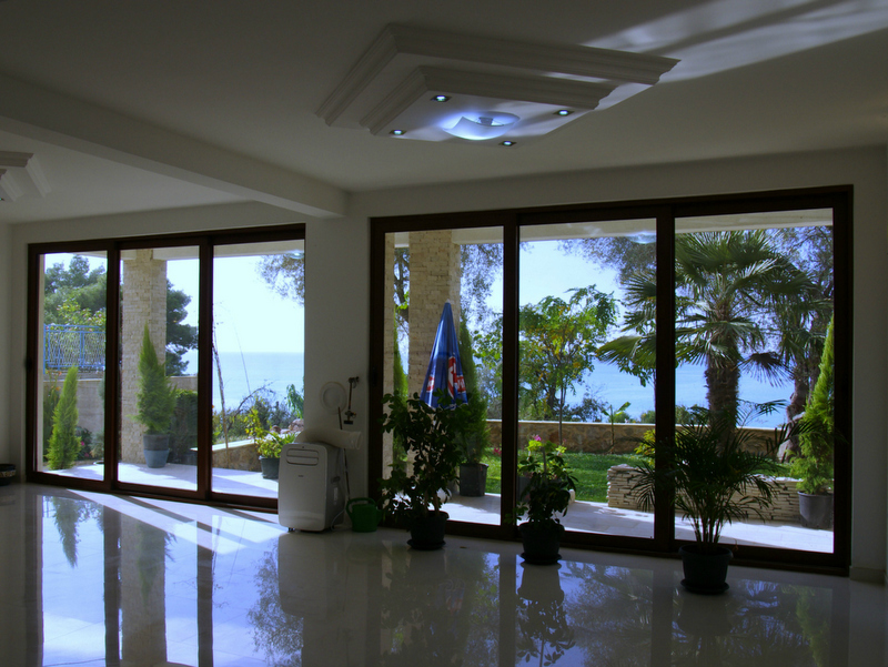 Living room with panoramic windows and sea view in a house, Sutomore, Bar Riviera, Montenegro. Bright interior.