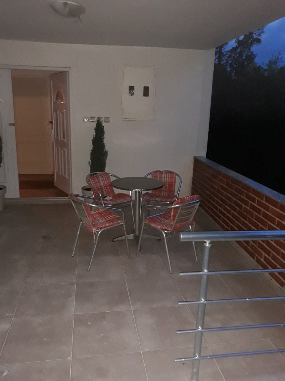 Cozy terrace with a dining area and brick railing in a house at the Žanjic resort, Montenegro.