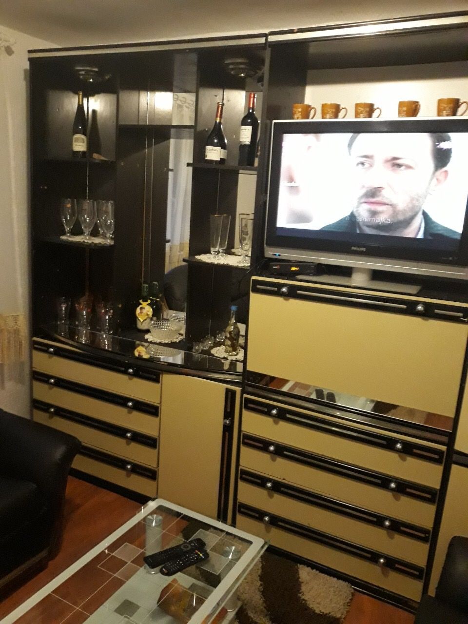 Living room in a house in Zhanice, Montenegro: a wall unit with display cabinet, TV, and coffee table in the interior.