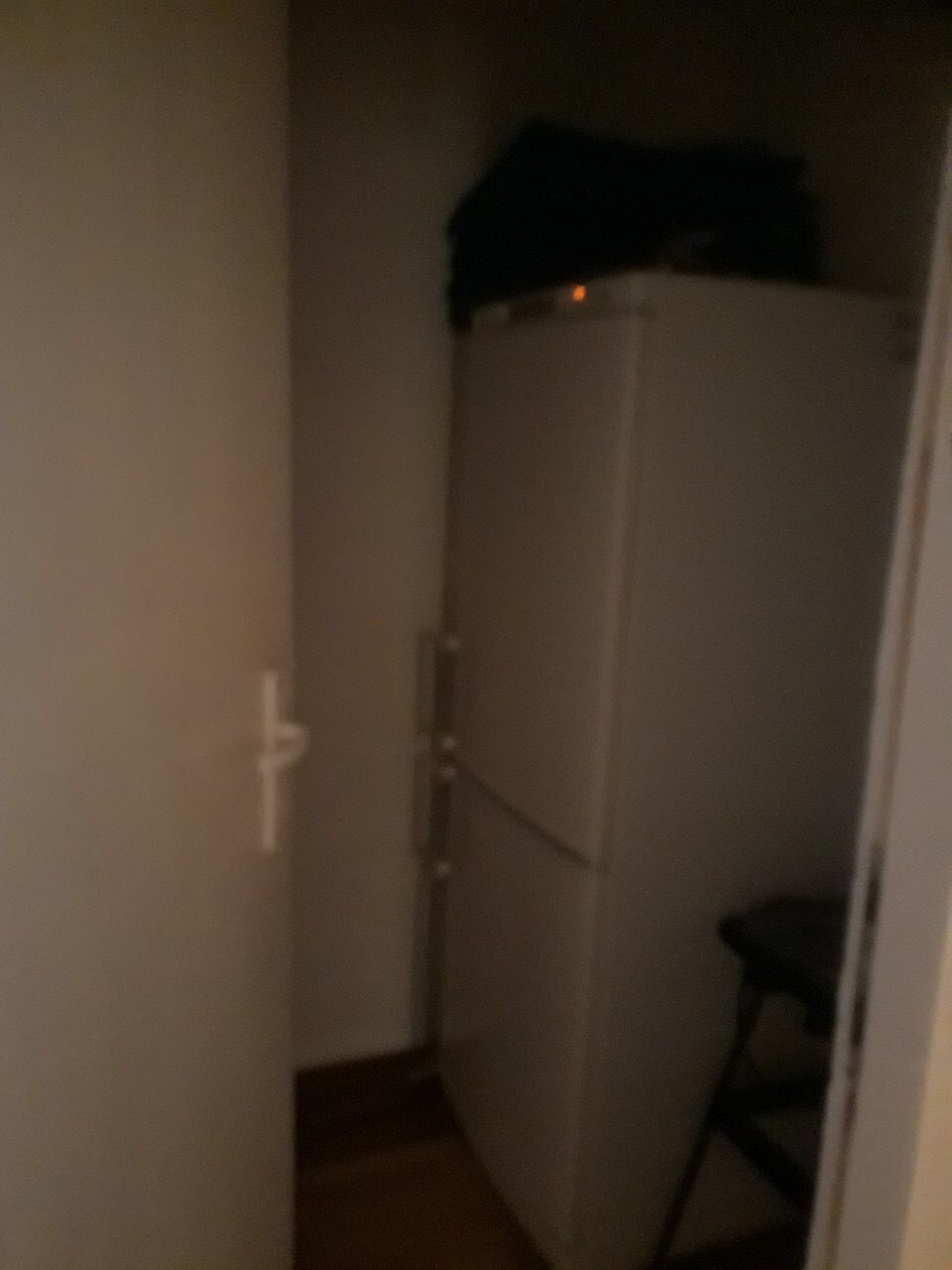 Double-door refrigerator in the kitchen alcove of a house in Zhanitsa, Montenegro, view of appliances in the interior.