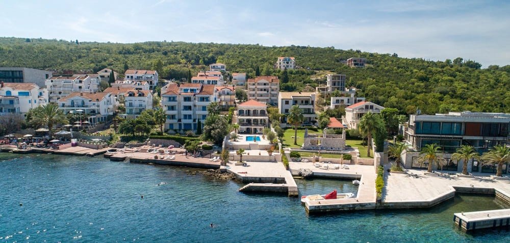 Aerial view of a villa in Krašići, Montenegro: private pool, terrace, private pier, and direct access to the sea.