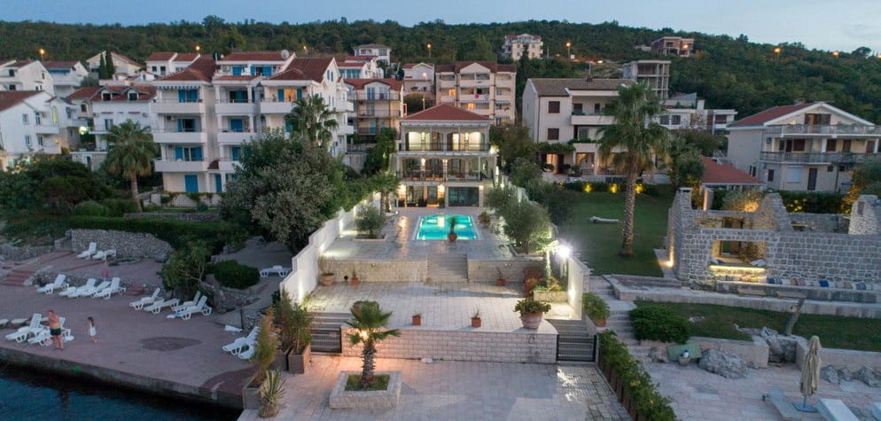 Villa in Krašići, Montenegro: aerial view of the house with a pool, terrace, garden, and private access to the sea.