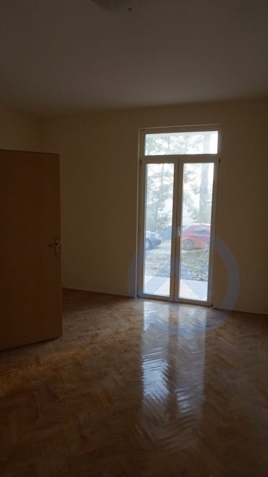 Bright living room with parquet flooring and access to the terrace in a house, Kavac, Montenegro.