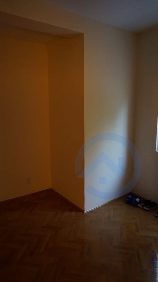 Empty bedroom with parquet flooring and light walls in a house for sale, Kavac, Montenegro.