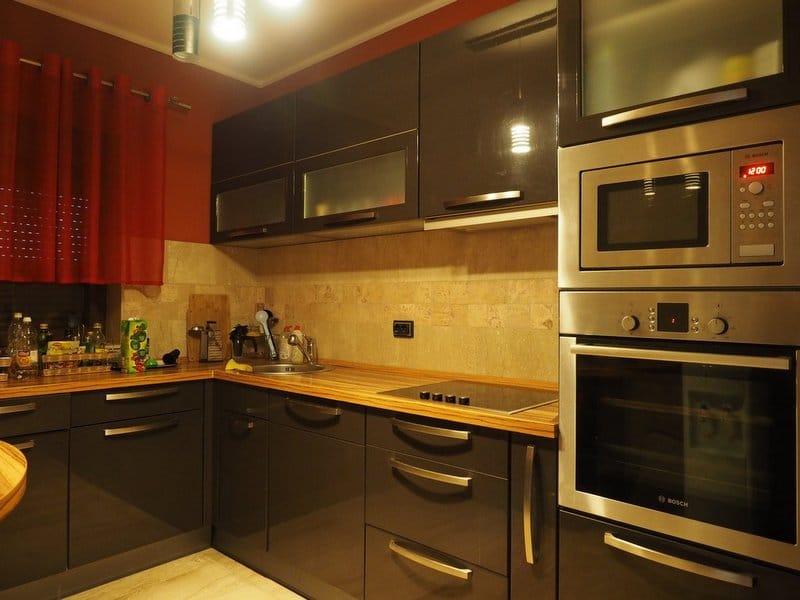 Modern kitchen with dark cabinets and Bosch appliances in a villa in Stoliv, Montenegro: stylish interior and finishes.