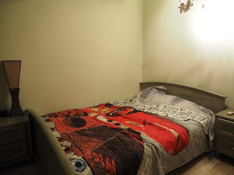 Cozy bedroom with a double bed and bedside tables in a villa in Stoliv, Montenegro.