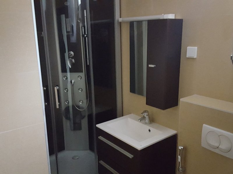 Modern bathroom with a shower cabin and vanity in an apartment, Dobrota, Montenegro.