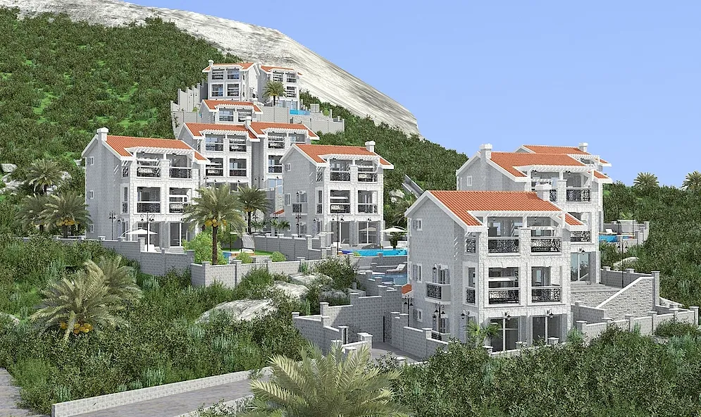 Exterior view of a multi-story residential complex with red roofs on a green hillside with palm trees.