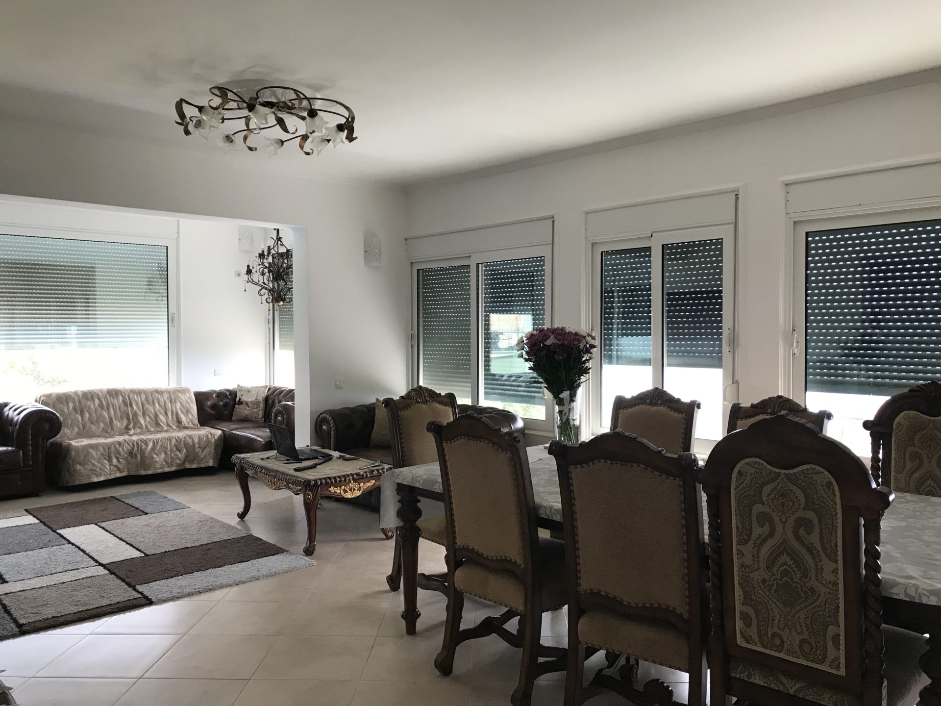 Spacious living room with classic furniture in a house in Bar, Montenegro: dining area and seating area.