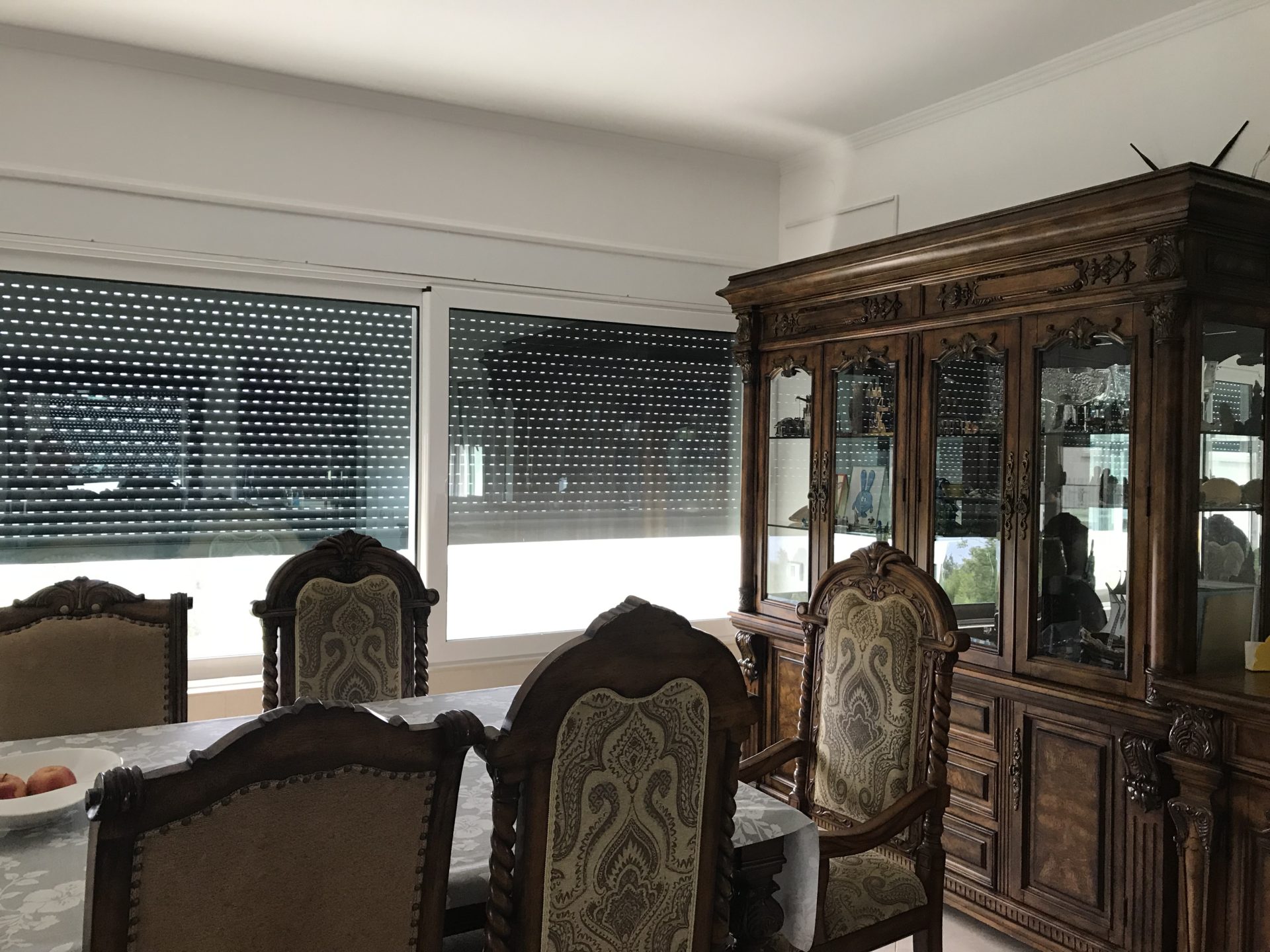 Classic dining room with a carved wooden sideboard and chairs in a house for sale, Bar, Montenegro.