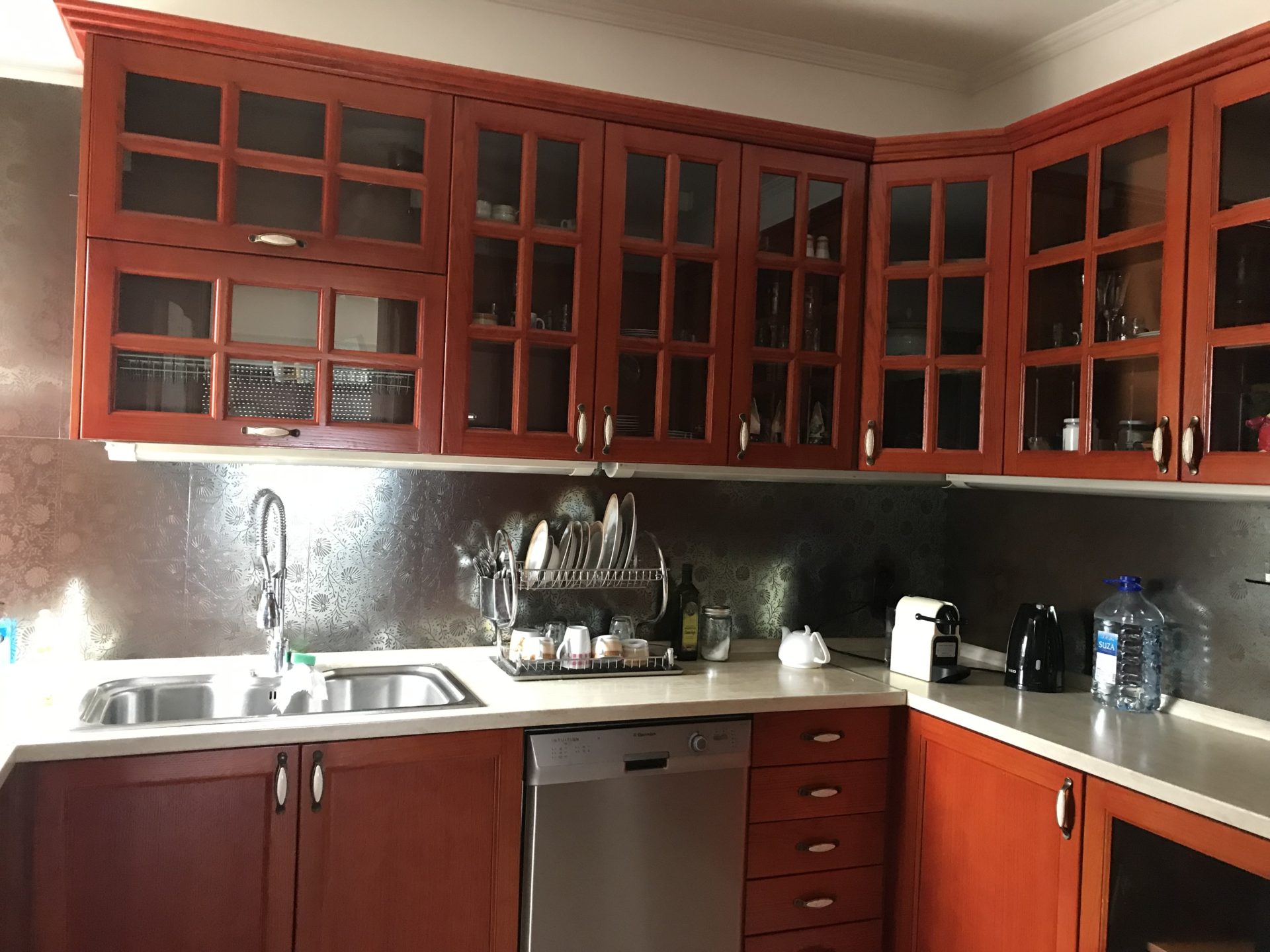 Corner kitchen with wooden fronts and built-in appliances in a house for sale, Bar, Montenegro.