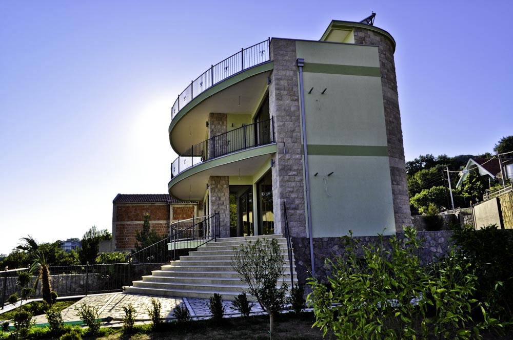 Modern villa with stone cladding and panoramic balconies in Šušanj, Montenegro: view of the facade and surrounding grounds