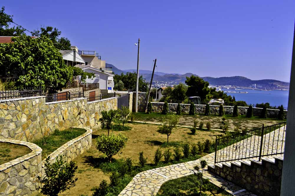 View of the landscaped villa grounds in Šušanj, Montenegro, with stone terraces and panoramic views of the Adriatic Sea