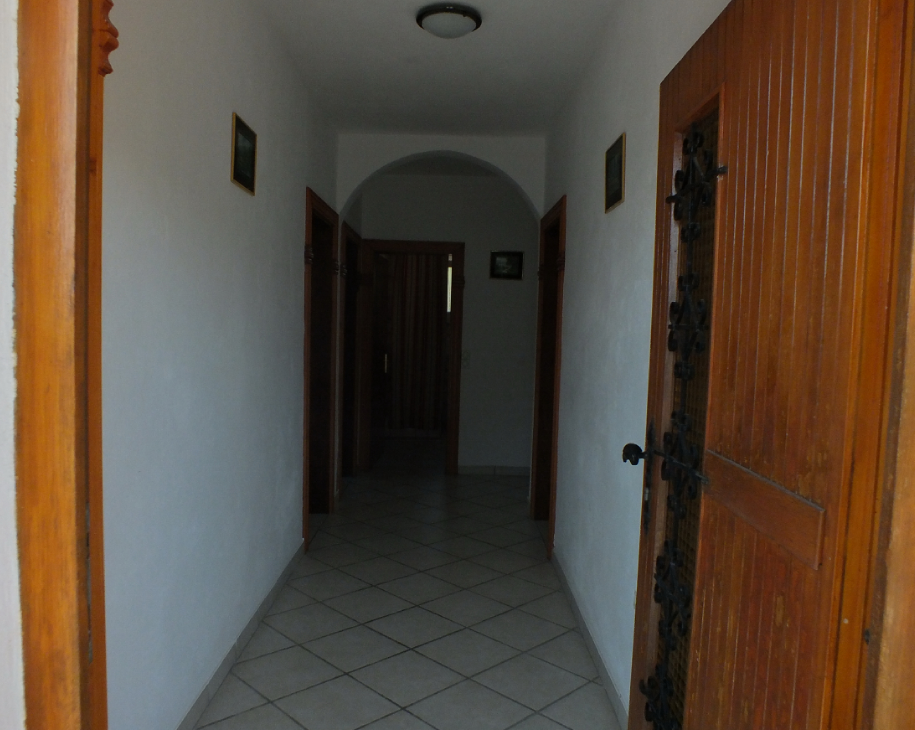 Bright hallway with an arched passage and wooden doors in a house for sale in Bar, Montenegro.