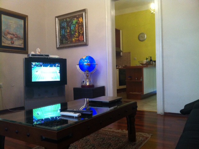 Living room with TV and coffee table in a house in Herceg Novi, Montenegro: view of the kitchen and interior decor.