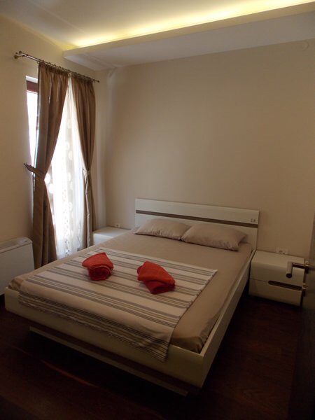 Cozy bedroom with a double bed in an apartment in Budva, Montenegro: modern furniture and a bright interior.