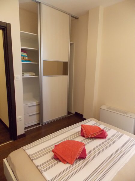 Bedroom in an apartment in Budva, Montenegro: double bed, built-in wardrobe, and light interior finishes.